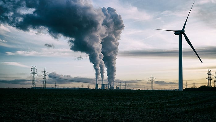 The image displaying a captivating scene, where a wind turbines smoke, a forecast symbol, rises against the sky.