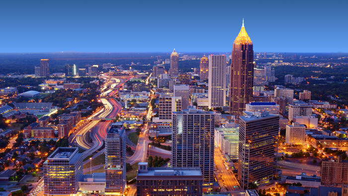 Overview of a city skyline at night.